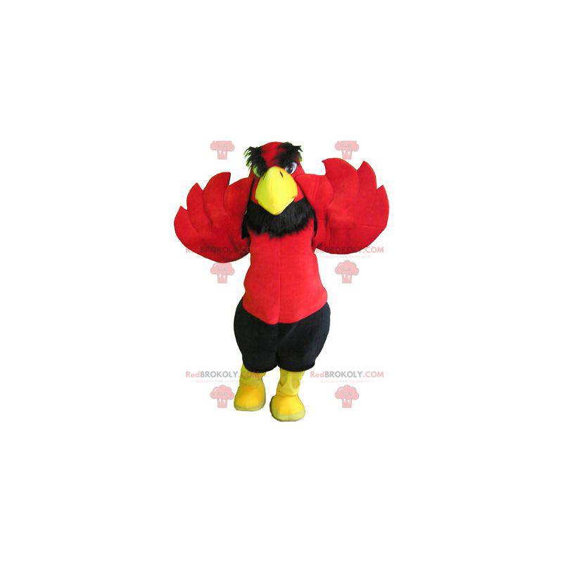Mascota águila roja y amarilla con pantalón negro -