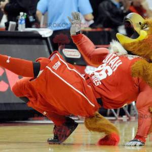 Brown and yellow muscular eagle mascot in sportswear -