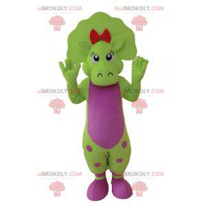 Green and pink dinosaur mascot with dots - Redbrokoly.com