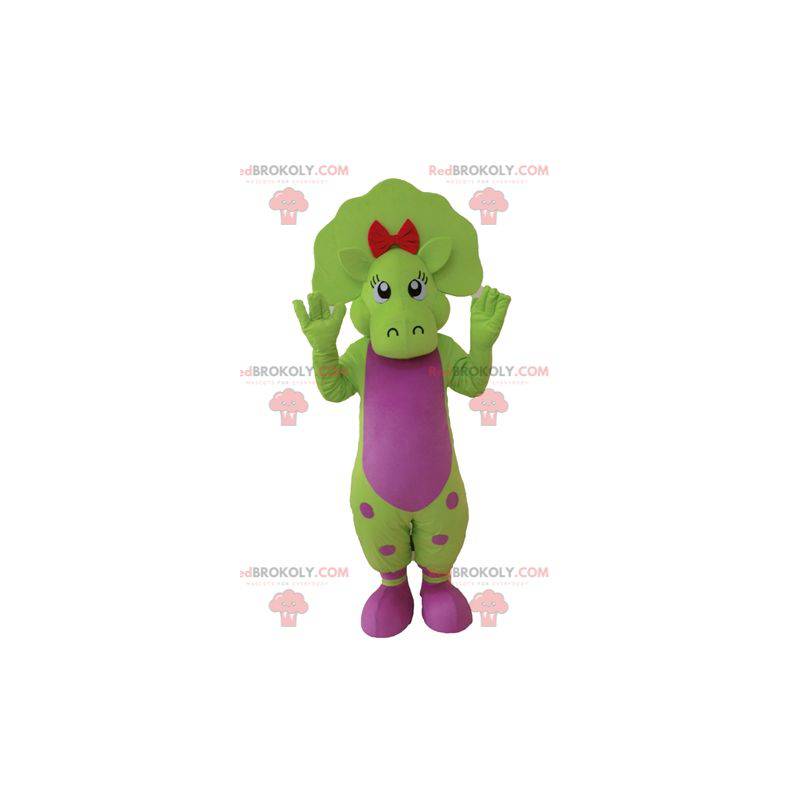 Grünes und rosa Dinosauriermaskottchen mit Punkten -