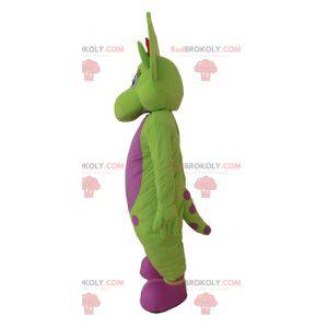 Mascote dinossauro verde e rosa com pontos - Redbrokoly.com