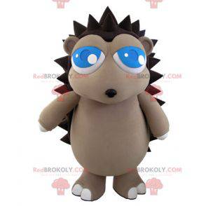 Graues und braunes Igelmaskottchen mit hübschen blauen Augen -