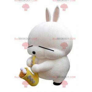 Mascote grande coelho branco com um saxofone - Redbrokoly.com
