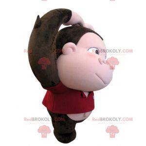 Mascote macaco marrom e rosa com uma cabeça grande -