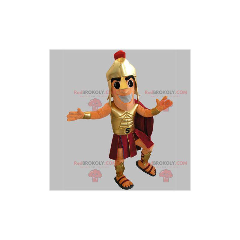 Mascota de gladiador en traje dorado y rojo - Redbrokoly.com