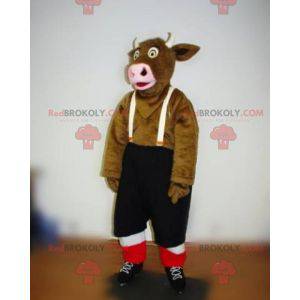 Mascotte della mucca marrone con pantaloncini bretelle -