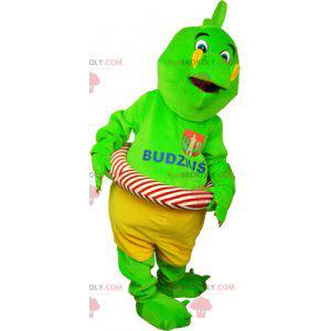 Flashy green dinosaur mascot in shorts with a buoy -