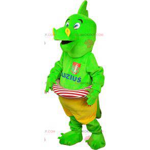 Mascotte de dinosaure vert flashy en short avec une bouée -