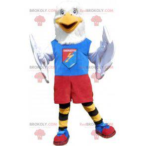 Mascota águila blanca en ropa deportiva colorida -