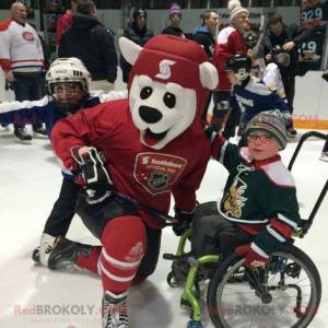 Mascotte dell'orso polare in attrezzatura da hockey rossa -