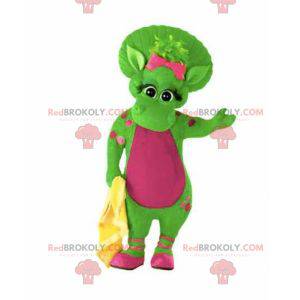 Riesiges und warmes grünes und rosa Dinosauriermaskottchen -