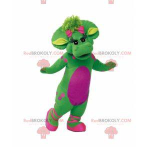 Mascotte de dinosaure vert et rose géant et chaleureux -