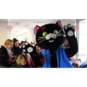 Černá a růžová kočka maskot oblečený v modré barvě -