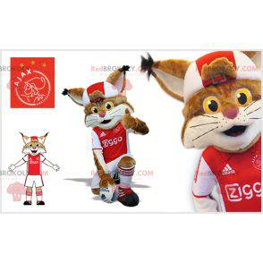 Mascotte lince marrone e bianca in abito da calciatore -