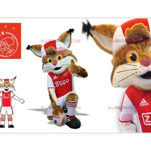Mascotte lince marrone e bianca in abito da calciatore -