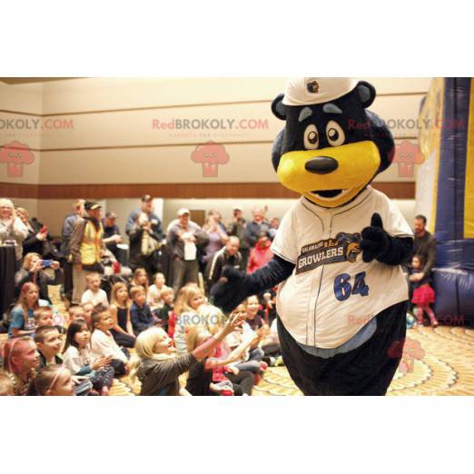 Black and yellow bear mascot in white outfit - Redbrokoly.com