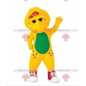 Mascote de dinossauro amarelo e verde com tênis - Redbrokoly.com