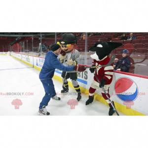 Mascot blond boy and black killer whale in hockey gear -