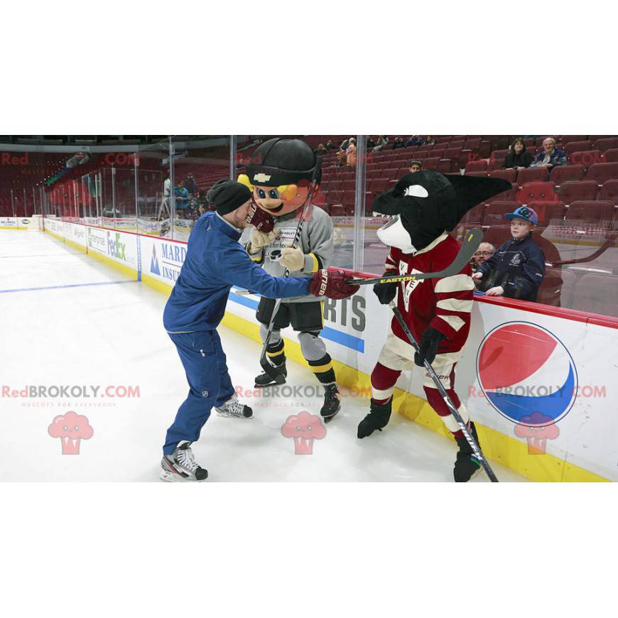 Mascot blond boy and black killer whale in hockey gear -