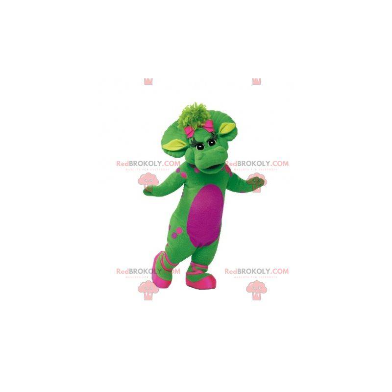 Mascote gigante e elegante de dinossauro verde e rosa -