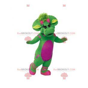 Mascota dinosaurio verde y rosa gigante y elegante -
