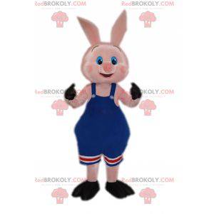 Mascotte de cochon en tenue de catch en salopette bleue -