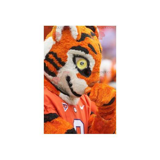 Mascotte de tigre orange noir et blanc en tenue de sport -