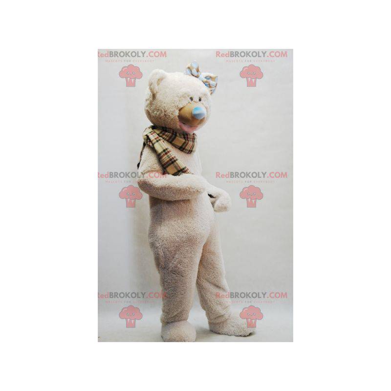 Mascota de oso de peluche beige con una bufanda a cuadros -