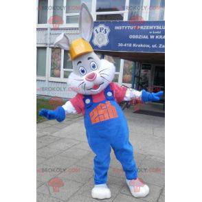 Gray and white rabbit mascot with overalls and headphones -