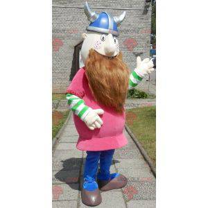 Mascote Viking barbudo vestido de rosa com um capacete -