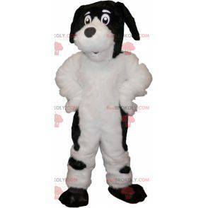 Haariges und süßes weißes und schwarzes Hundemaskottchen -