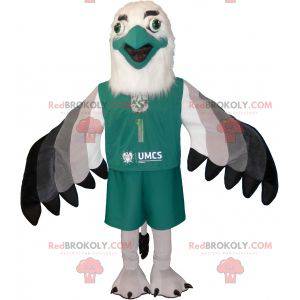 Mascotte avvoltoio grigio bianco e nero vestita di verde -