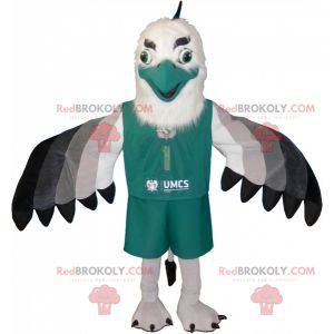 White and black gray vulture mascot dressed in green -