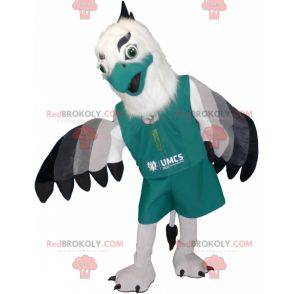 White and black gray vulture mascot dressed in green -