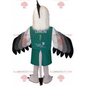 Mascotte de vautour gris blanc et noir habillé en vert -