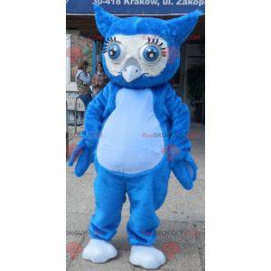 Reusachtige blauwe uil mascotte met grote blauwe ogen -