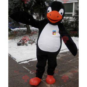 Mascotte de pingouin noir blanc et orange. Costume de pingouin