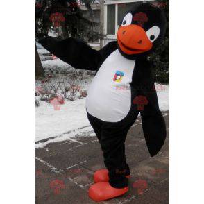 Mascotte de pingouin noir blanc et orange. Costume de pingouin