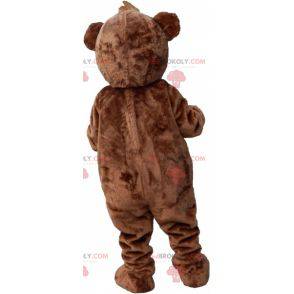 Brown and white teddy bear mascot with a crest - Redbrokoly.com