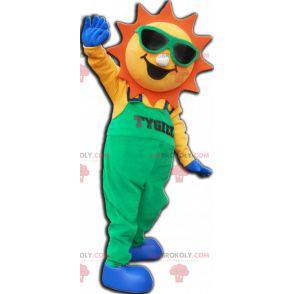 Mascotte de soleil habillé d'une salopette verte -