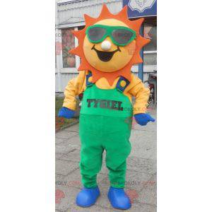 Sonnenmaskottchen in grünen Overalls - Redbrokoly.com