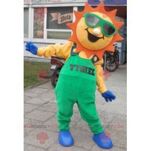 Mascote do sol vestido de macacão verde - Redbrokoly.com