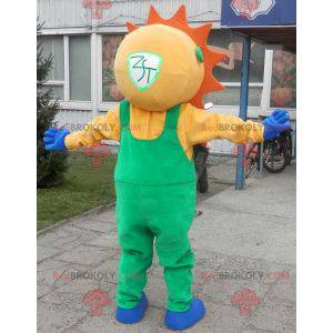 Mascotte de soleil habillé d'une salopette verte -