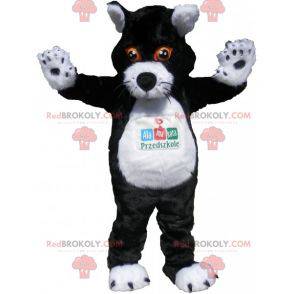 Schwarzweiss-Katzenmaskottchen mit orangefarbenen Augen -