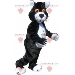 Schwarzweiss-Katzenmaskottchen mit orangefarbenen Augen -
