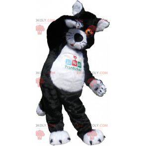 Schwarzweiss-Katzenmaskottchen mit orangefarbenen Augen -