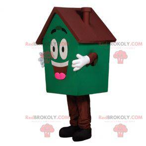 Mascotte de maison géante verte et marron très souriante -