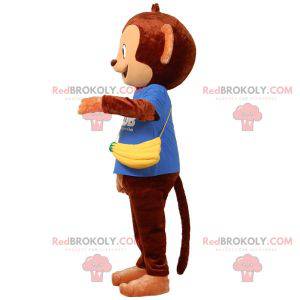 Mascote macaco marrom com um saco em forma de banana -