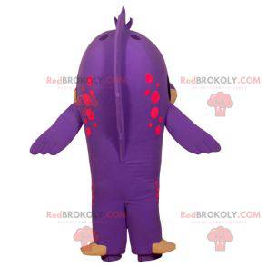 Mascotte di pesce viola e beige divertente e sorridente -