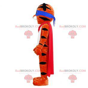 Mascota tigre naranja y negro con una diadema y una capa -